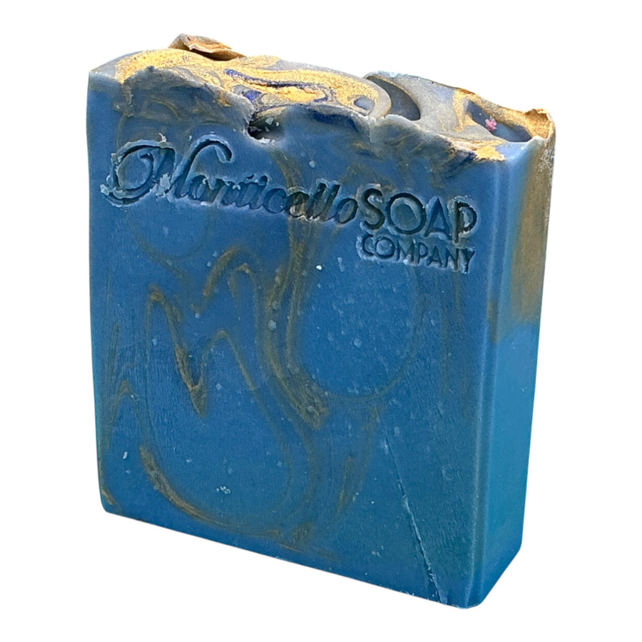 Midnight Waters with Gold handcrafted bar soap by Monticello Soap Company, deep blue oceanic bar with charcoal and gold shimmer top.
