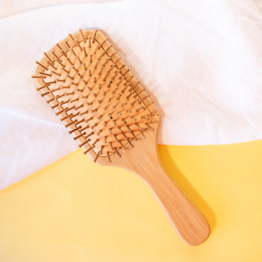 Anti-frizz bamboo hair brush by Humby Organics, a plastic-free natural hair brush for detangling