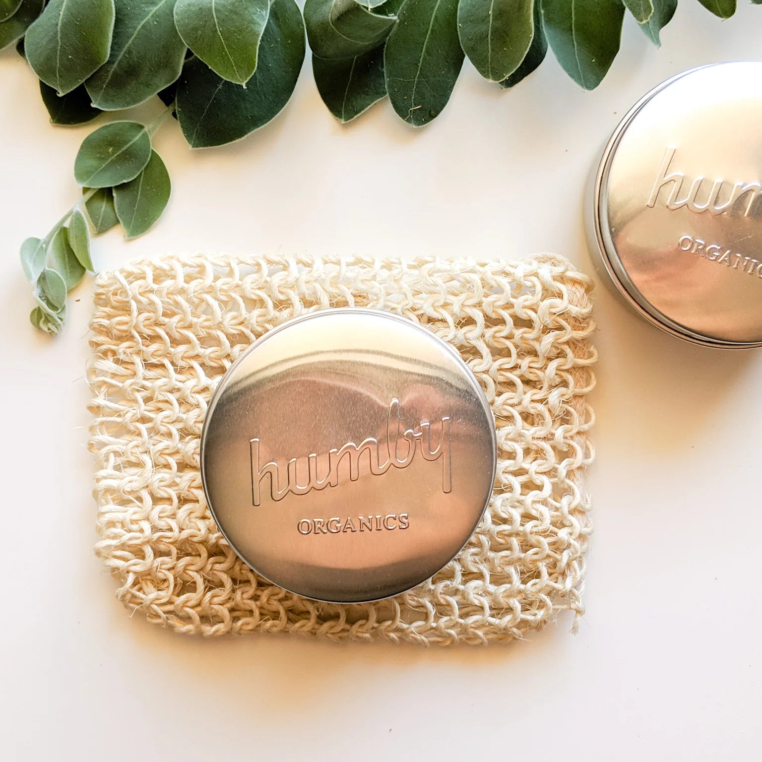 Stainless steel shampoo bar travel tin by Humby Organics, a plastic-free reusable case for shampoo and conditioner bars